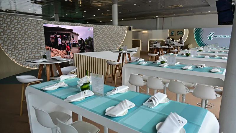 Dining tables laid with white napkins inside a Paddock Club hall above the pit building at Sepang International Circuit